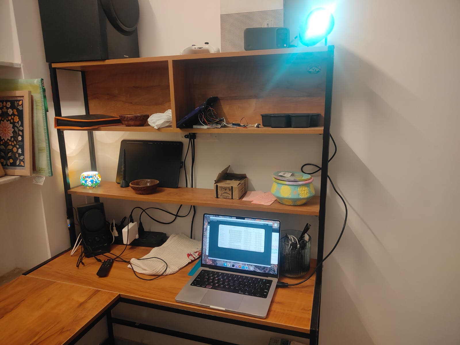 The desk: MacBook below, phone and projector on the top shelf